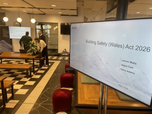 65 inch tv on mobile trolley stand setup for a business presentation in a Cardiff conference room.